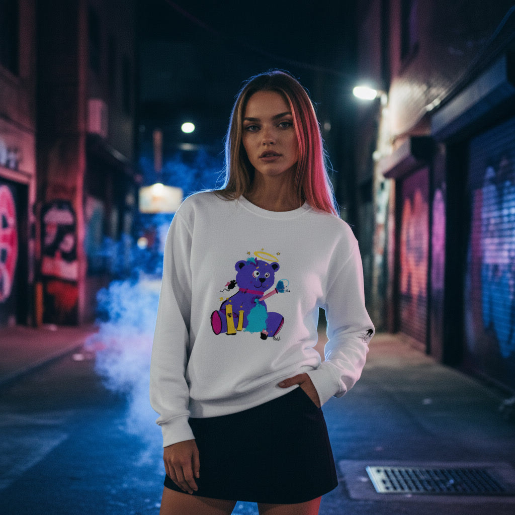 Woman wearing a white sweatshirt with a colorful graphic in an urban alley at night.