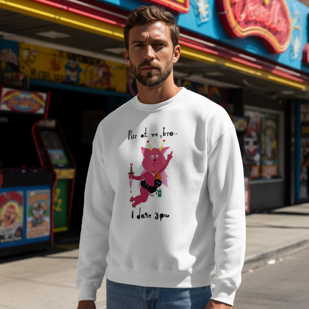 Man wearing a white sweatshirt with a graphic design in front of arcade machines.
