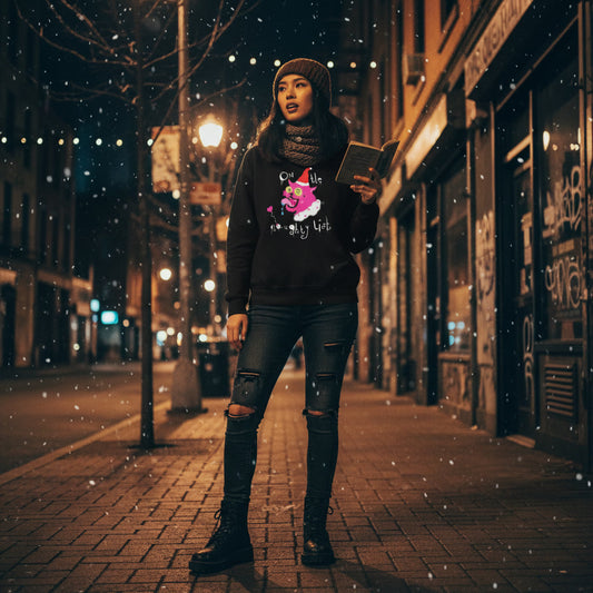 Person standing on a snowy street at night, holding a book.